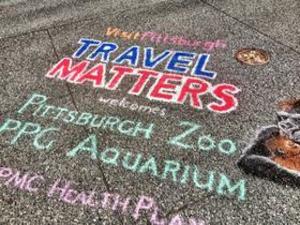 Chalk drawings were part of Tourism Day and the "Vote Travel" bus tour stop